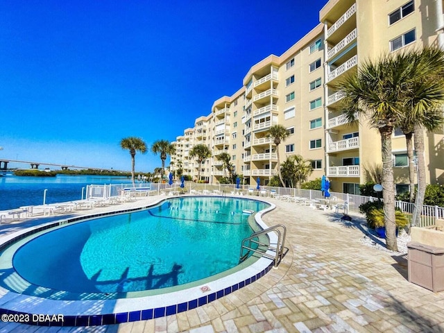 view of swimming pool with a water view