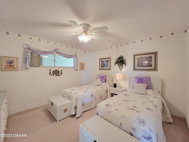 carpeted bedroom featuring a textured ceiling and ceiling fan