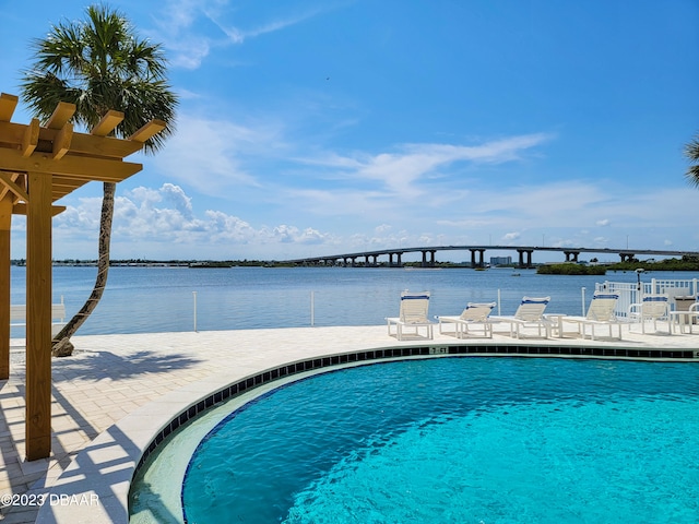 view of swimming pool with a water view