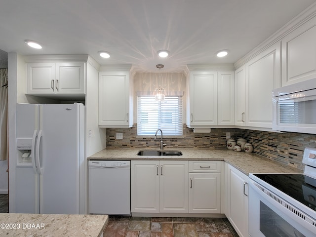 kitchen featuring sink, hanging light fixtures, white appliances, white cabinets, and decorative backsplash