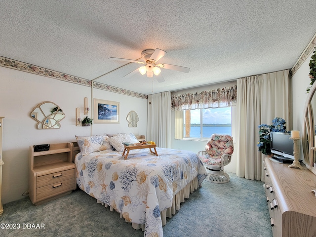 carpeted bedroom featuring a textured ceiling and ceiling fan