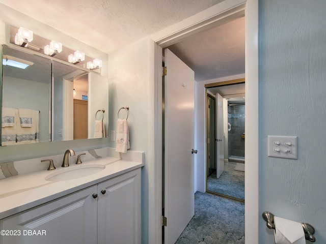 bathroom with vanity and a textured ceiling