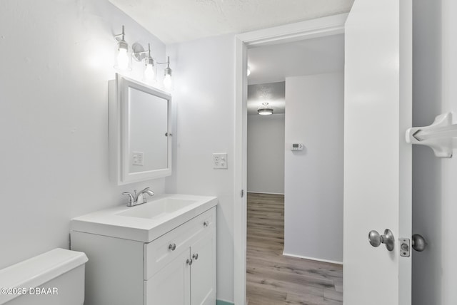 2711 N Halifax Ave Unit 380, Daytona Beach, FL 32118 - bathroom with vanity, toilet, and wood finished floors