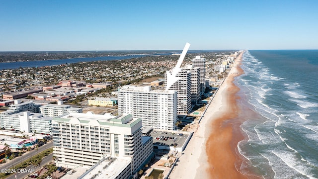 birds eye view of property with a water view and a beach view