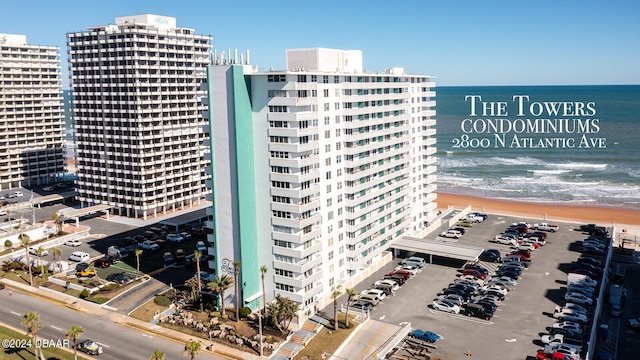 view of building exterior featuring a view of the beach and a water view