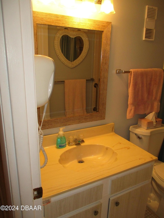 bathroom featuring vanity and toilet