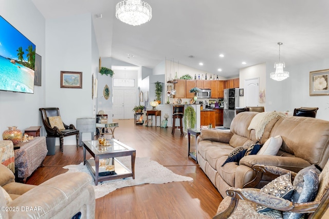 19343 Moorgate St, Orlando, FL 32833 - living area with a chandelier, vaulted ceiling, light wood-type flooring, and recessed lighting