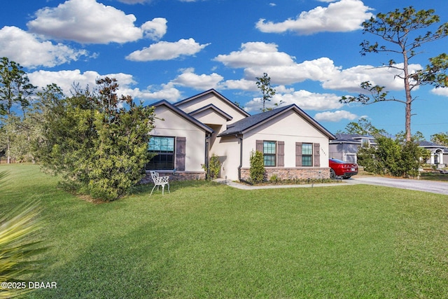 19343 Moorgate St, Orlando, FL 32833 - ranch-style home with stucco siding, a front lawn, and stone siding