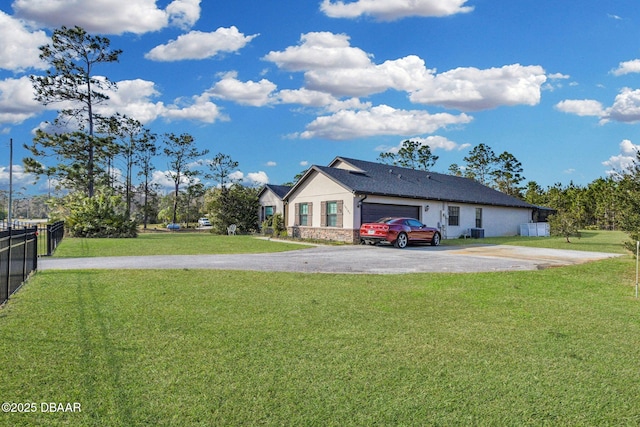 19343 Moorgate St, Orlando, FL 32833 - view of yard with asphalt driveway, an attached garage, and central AC unit