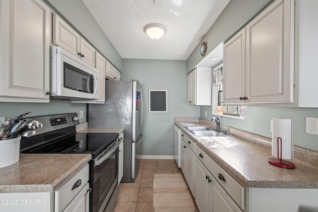 840 Center Ave Unit 21, Holly Hill, FL 32117 - kitchen featuring stainless steel electric range, white microwave, light tile patterned floors, a textured ceiling, and a sink