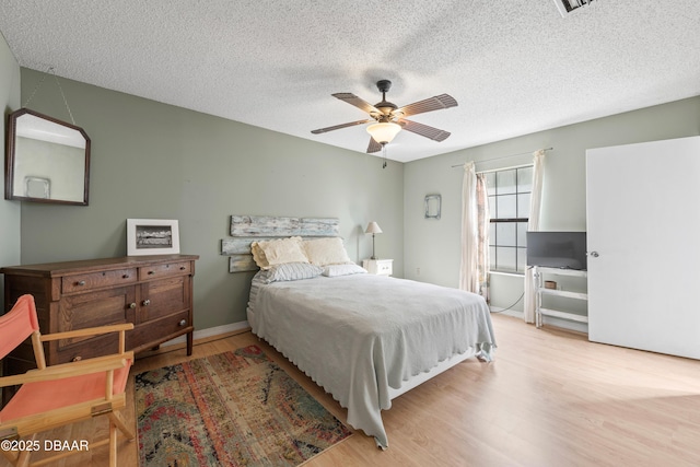840 Center Ave Unit 21, Holly Hill, FL 32117 - bedroom featuring baseboards, a ceiling fan, wood finished floors, and a textured ceiling