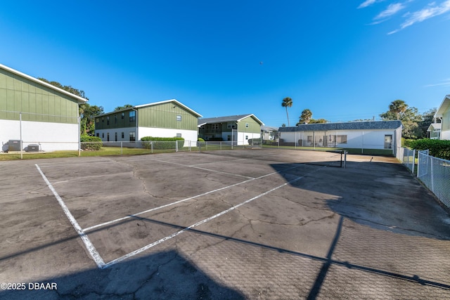 840 Center Ave Unit 21, Holly Hill, FL 32117 - uncovered parking lot featuring a tennis court and fence