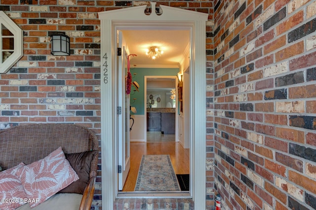 entrance to property featuring brick siding