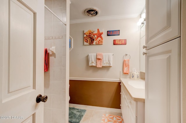 bathroom with tile patterned flooring, visible vents, vanity, baseboards, and ornamental molding