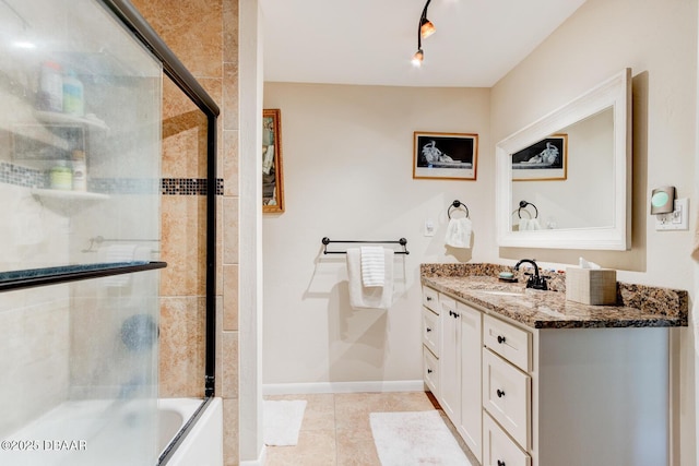 full bath with baseboards, bath / shower combo with glass door, tile patterned flooring, and vanity