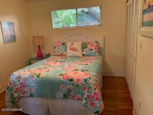 bedroom with wood finished floors and baseboards