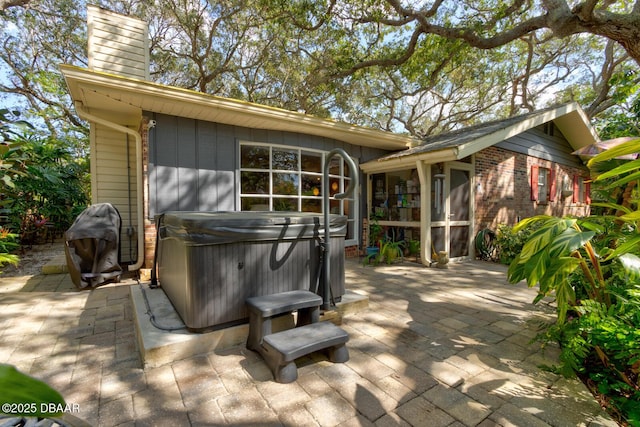 view of patio featuring a grill and a hot tub