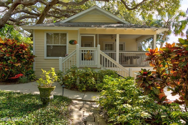 view of front of home featuring a porch, stairway, and a ceiling fan