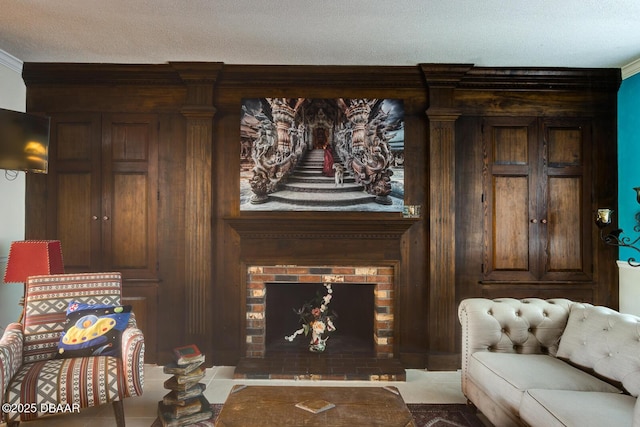 living area with ornamental molding, a fireplace, and a textured ceiling