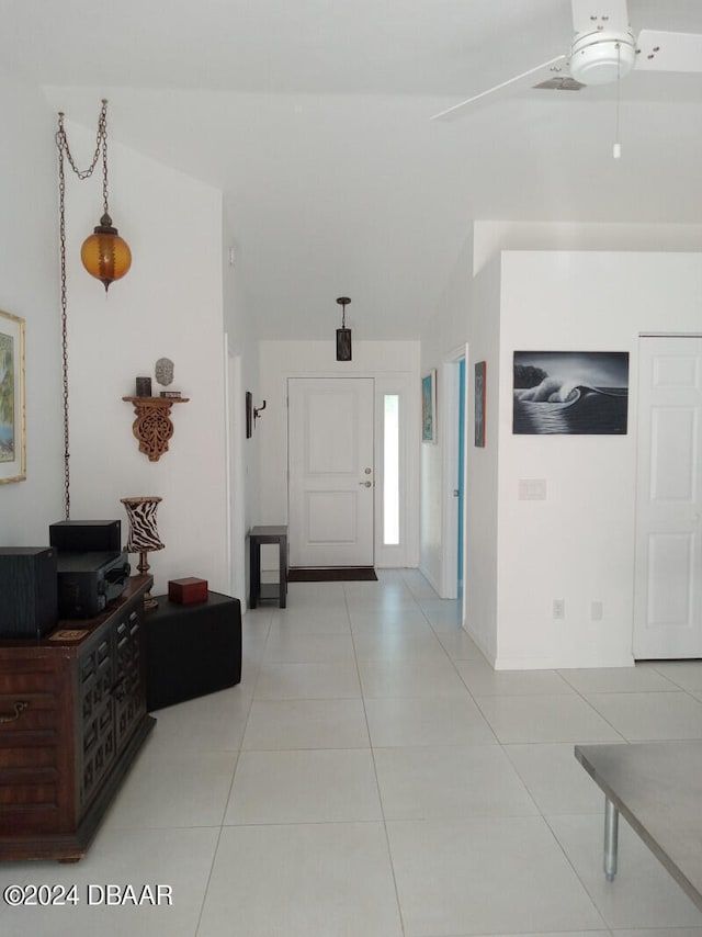 tiled foyer entrance featuring ceiling fan and lofted ceiling