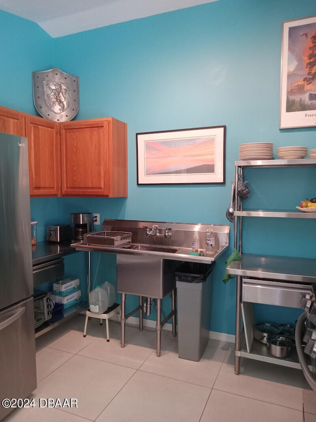 kitchen with stainless steel refrigerator and light tile patterned flooring