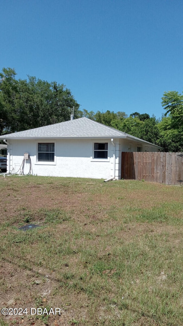 view of property exterior featuring a lawn