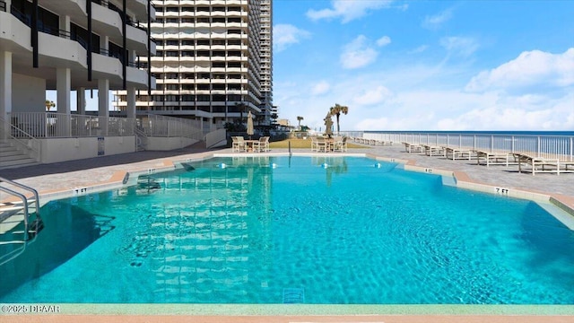 view of swimming pool featuring a water view