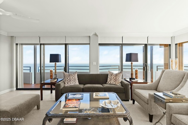 living room with a water view, ornamental molding, and a wealth of natural light