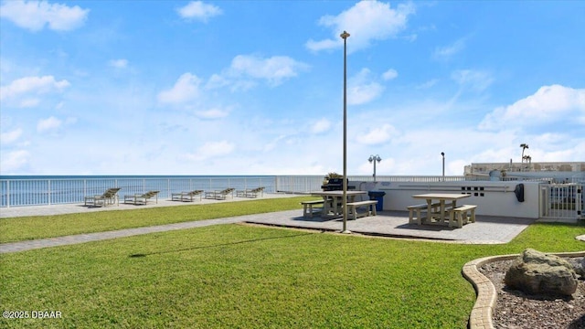 view of yard with a patio area and a water view