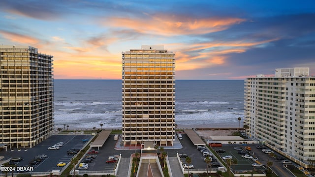 exterior space featuring a water view and a beach view