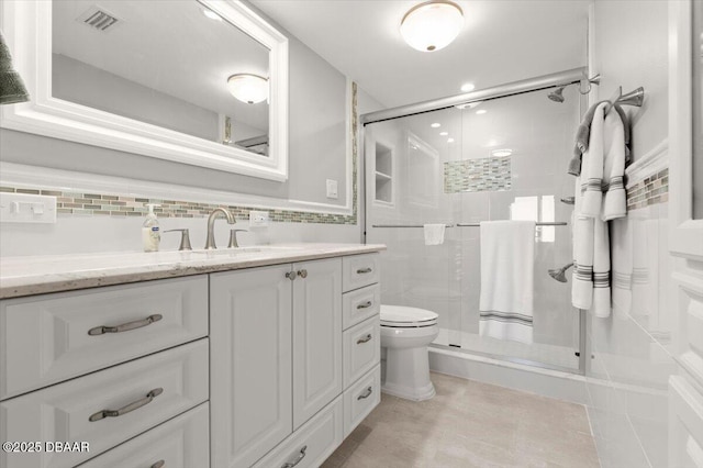 bathroom with vanity, tile walls, an enclosed shower, and toilet