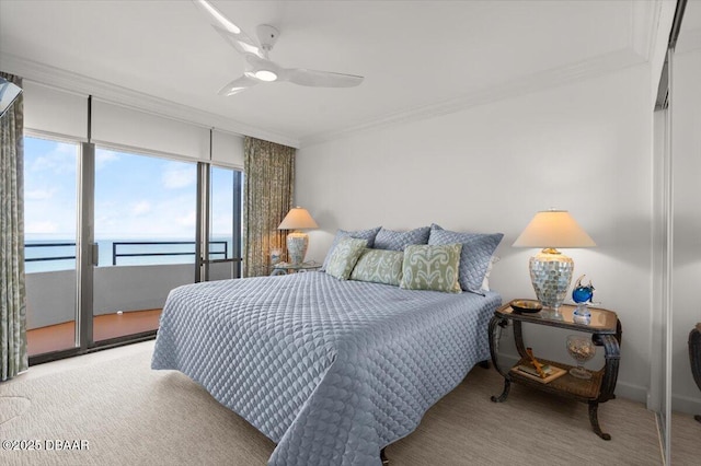 carpeted bedroom with access to outside, ornamental molding, ceiling fan, and a water view