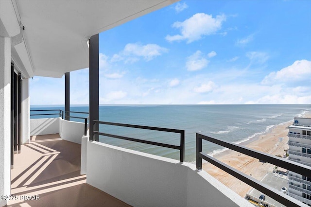 balcony with a water view and a beach view