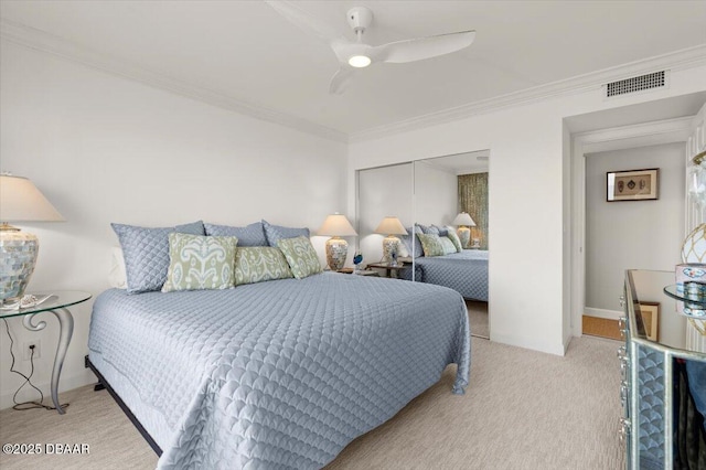 bedroom featuring ceiling fan, light colored carpet, ornamental molding, and a closet