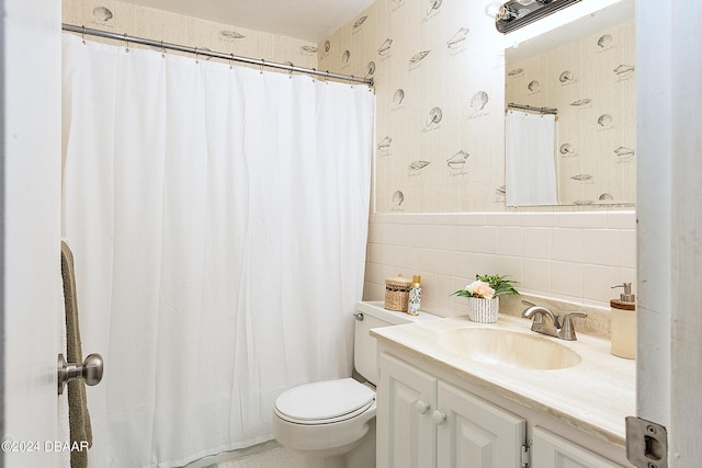 bathroom with toilet, vanity, backsplash, and tile walls