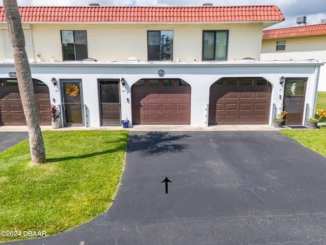 view of front of house featuring a garage and a front lawn