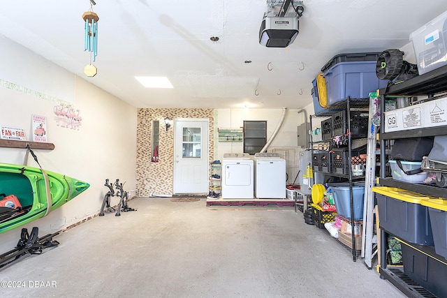 garage featuring washer and clothes dryer, a garage door opener, and water heater