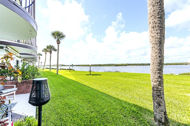 view of yard featuring a balcony and a water view