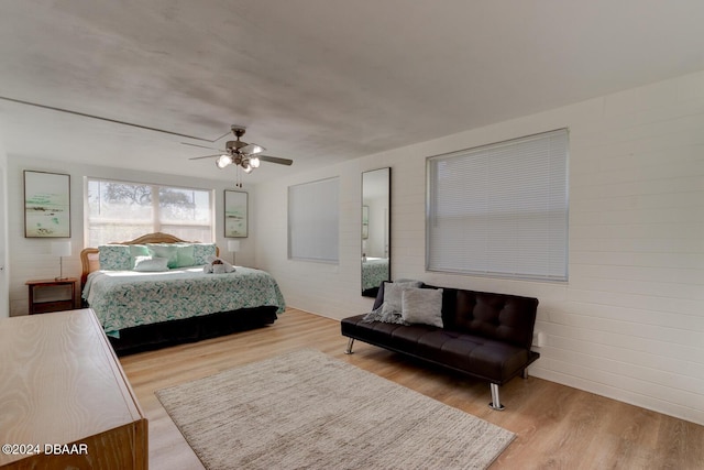 bedroom with hardwood / wood-style floors and ceiling fan