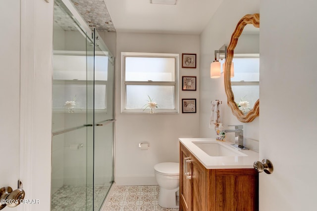 bathroom featuring tile patterned flooring, vanity, toilet, and walk in shower