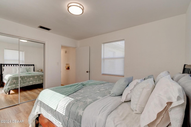 bedroom featuring hardwood / wood-style floors and a closet