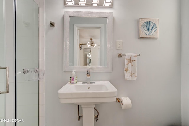 bathroom with ceiling fan and an enclosed shower