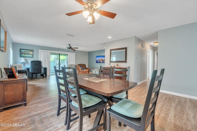 dining room with light hardwood / wood-style floors and ceiling fan