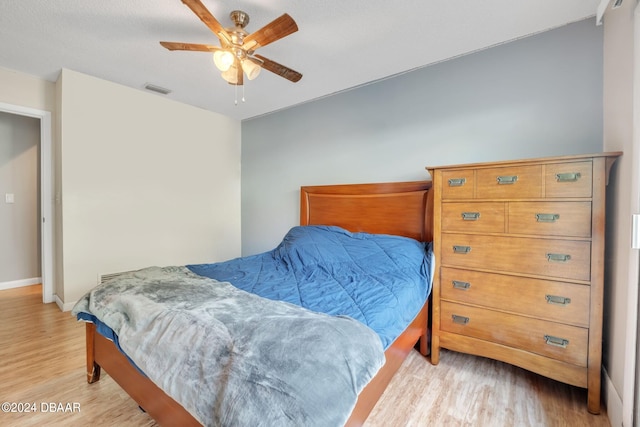 bedroom with light wood-type flooring and ceiling fan