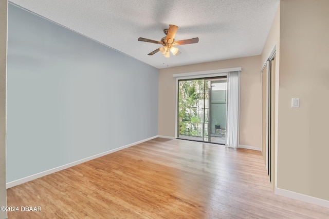 spare room featuring light hardwood / wood-style flooring, a textured ceiling, and ceiling fan