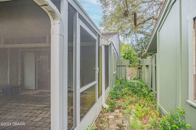 view of property exterior featuring a sunroom