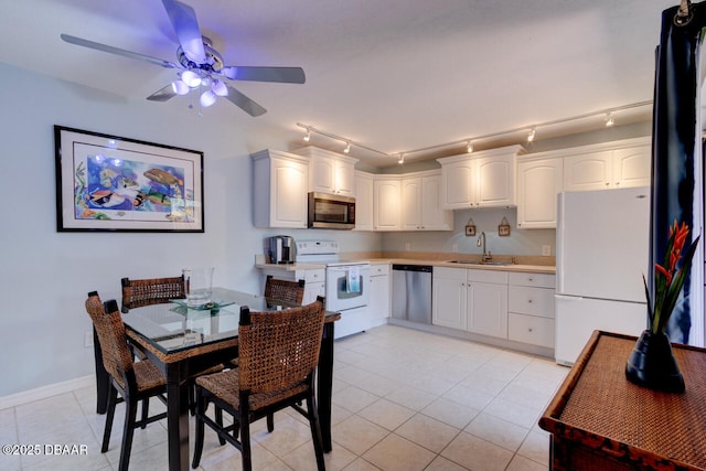 122 Cedar Dunes Dr, New Smyrna Beach, FL 32169 - kitchen featuring stainless steel appliances, a sink, white cabinetry, a ceiling fan, and light tile patterned flooring