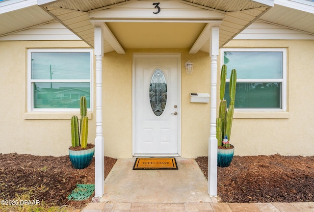 property entrance with stucco siding