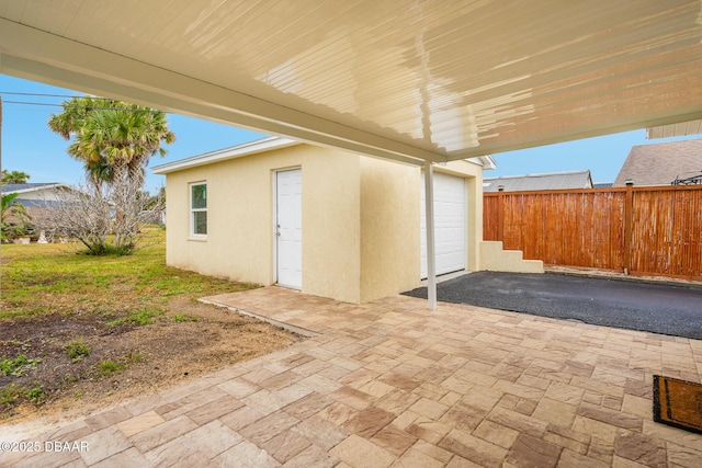 view of patio with a garage and fence