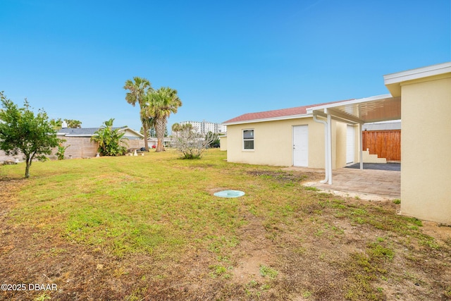 view of yard with a patio and fence